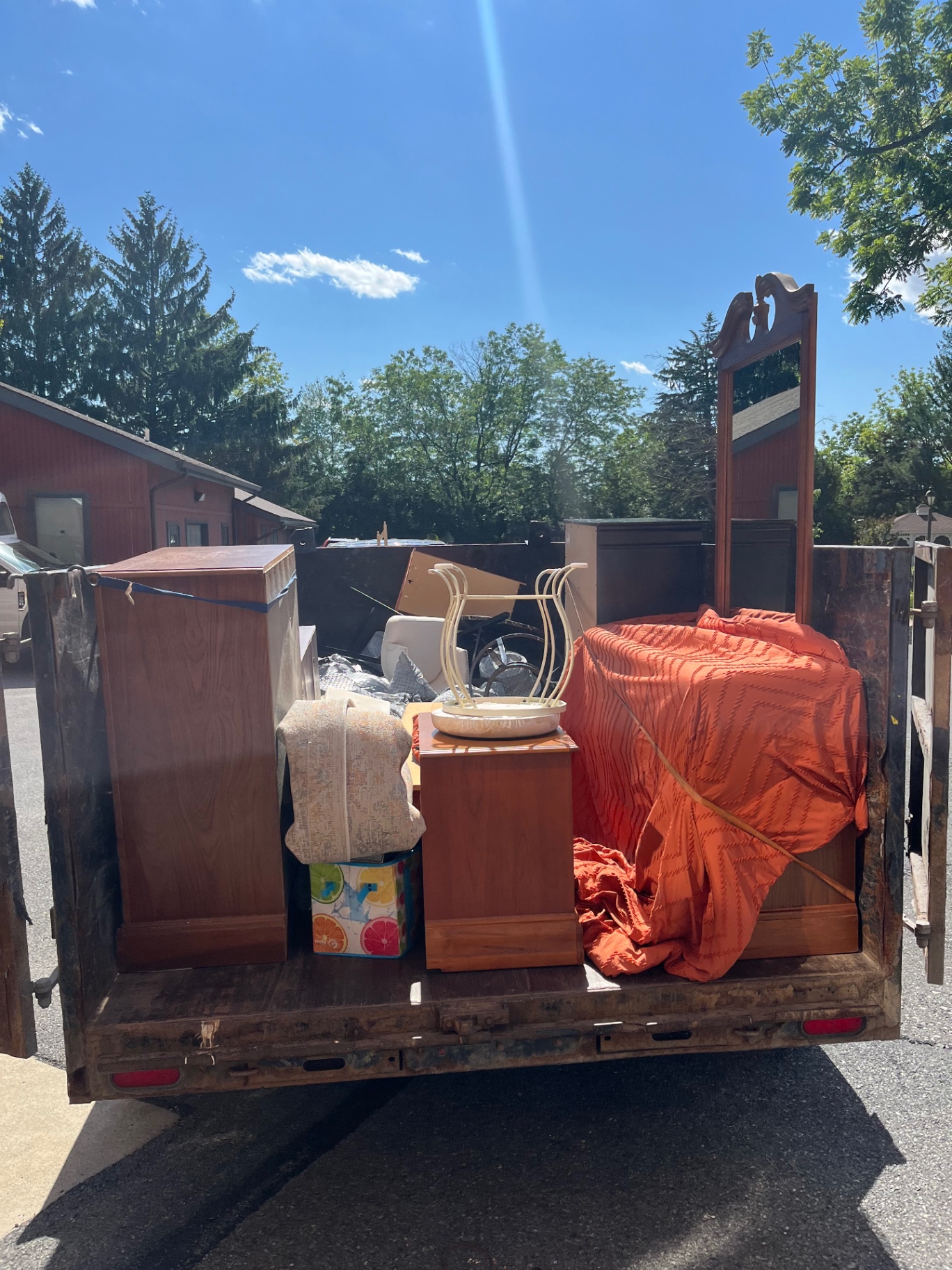 Anytime Junk Removal trailer fully loaded with furniture, mattresses and household debris